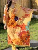 Vibrant floral printed cotton suit with an embellished neckline in yellow, featuring bold orange, red, and purple flowers.