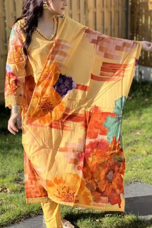 Vibrant floral printed cotton suit with an embellished neckline in yellow, featuring bold orange, red, and purple flowers.